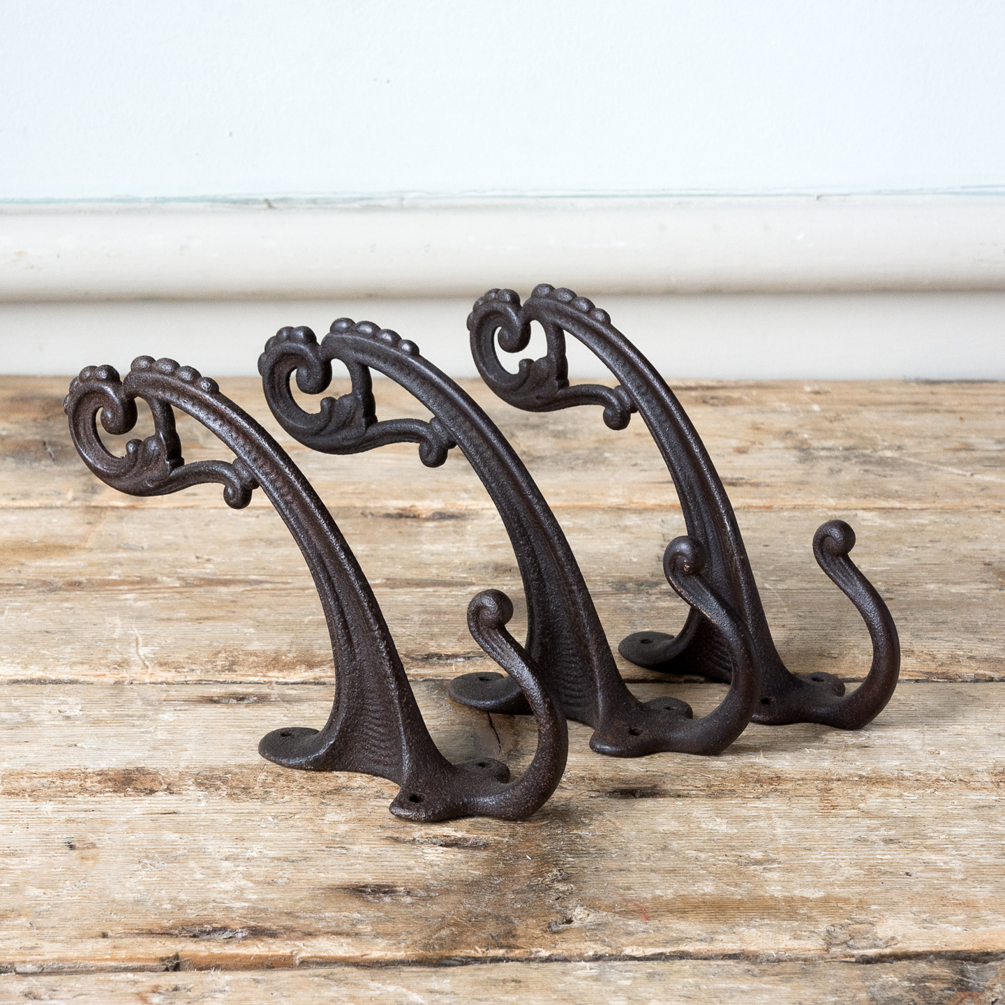 Three Victorian cast iron coat hooks, - LASSCO - England's prime